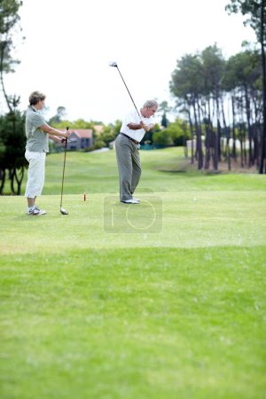 Photo for Old couple, sports or golfer playing golf for fitness, workout or exercise to swing on course or field. Senior woman, elderly man golfing or training in practice game to strike a ball in retirement. - Royalty Free Image