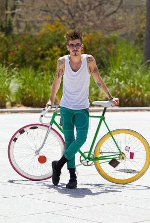Photo for Portrait, bike and a hipster man in the city for eco friendly travel, sustainability or carbon neutral transportation. Fashion, retro and a cyclist standing with a vintage bicycle in an urban town. - Royalty Free Image