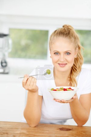 Photo for Fruit salad, eating or portrait of happy woman with a snack, morning breakfast or lunch diet in home kitchen. Face, gut health or girl with fruits, grapes or food bowl meal to lose weight or wellness. - Royalty Free Image