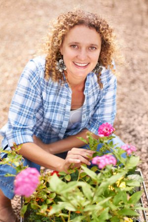 Photo for Happy, portrait and a woman gardening in nature for sustainability, ecology care and inspection. Smile, spring and a florist or girl with plants or flowers in a backyard or garden for lawn design. - Royalty Free Image