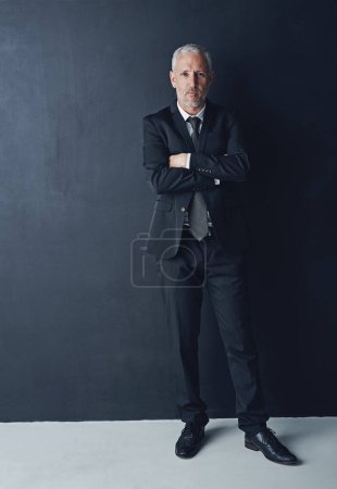 Photo for Portrait, serious and confident businessman with arms crossed in pride, lawyer or attorney on dark background. Boss, ceo and professional business owner, proud senior executive director at law firm - Royalty Free Image