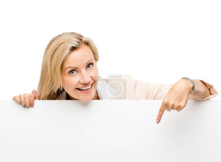 Photo for Banner, portrait and mature woman with hand pointing in studio to mockup, timeline or news on white background. Face, smile and happy lady show steps, menu or promo, announcement or coming soon deal. - Royalty Free Image