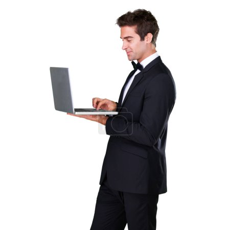Photo for Male waiter, typing and laptop with service and suit in white background is working at restaurant. Butler, bowtie and technology with man in hospitality with tuxedo, luxury and menu in studio - Royalty Free Image
