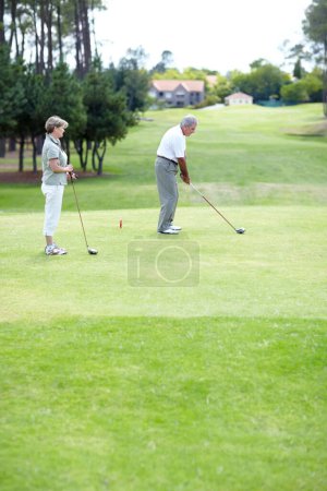 Photo for Old couple, sports or golfer playing golf for fitness, workout or exercise to swing on a course or field. Senior woman, elderly man golfing or training in practice game and driving with a club stroke. - Royalty Free Image
