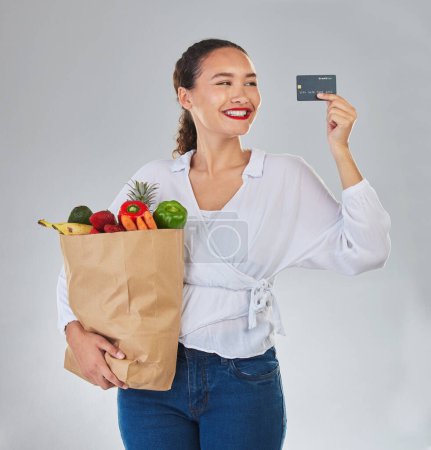 Photo for Credit card, online and woman grocery shopping for fruits, vegetables and studio isolated on a white background. Sustainable bag, food and happy customer with digital money, ecommerce and fintech - Royalty Free Image