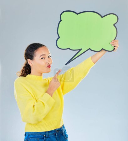 Photo for Woman, pointing and speech bubble portrait for question, social media or faq communication. Young female model with a sign or space for marketing, idea or opinion on a white studio background. - Royalty Free Image