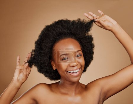 Photo for Portrait, beauty and black woman pulling hair, cosmetics and wellness against a brown studio background. Face, female person and model with luxury, playful and volume with fun, texture and shampoo. - Royalty Free Image