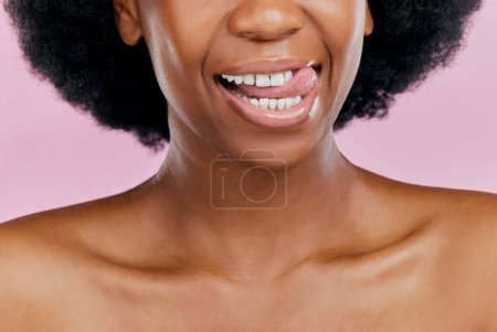 Photo for Black woman, mouth and tongue out, beauty and teeth with dental, health and hygiene on pink background. Lips, skin and African female model, oral care and grooming with healthy gums in studio. - Royalty Free Image