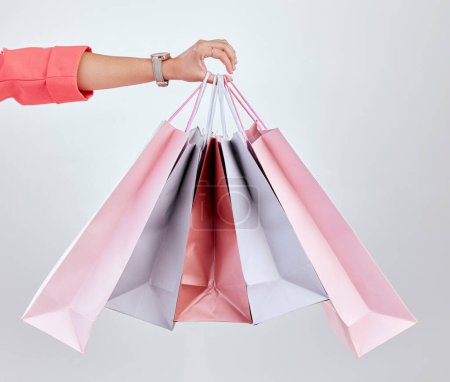 Photo for Fashion, studio or hand of woman with shopping bags for retail sale, product offer or discount deal. Choice, customer or girl shopper holding gift, package or present on promotion on white background. - Royalty Free Image