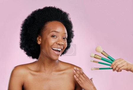 Photo for Portrait, smile and black woman with makeup, brushes and dermatology against a studio background. Face, female person or model with cosmetic tools, salon treatment and luxury with skincare and beauty. - Royalty Free Image