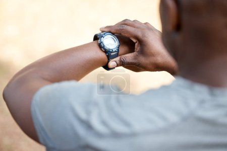 Photo for Man, check smart watch and fitness in park to monitor speed, heart or vital signs. Outdoor, male runner and iot clock for time, training stats or exercise with stopwatch, nature or summer for health. - Royalty Free Image