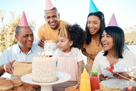 Photo for Birthday party, children and senior family outdoor for happy celebration, cake and grandparents with love and support. Excited people together, kids or girl in garden or patio, holiday and singing. - Royalty Free Image