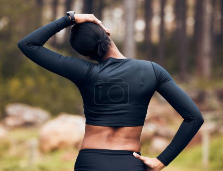 Photo for Exercise, stretching neck and back of woman in nature for fitness, training and sports in forest. Healthy body, mountain and female person getting ready with warm up, cardio workout and wellness. - Royalty Free Image