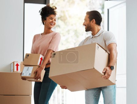Photo for Couple, box and excited in new home, happy or together for moving, beginning and commitment for mortgage. Man, woman with cardboard package, smile or start life in property, real estate and apartment. - Royalty Free Image