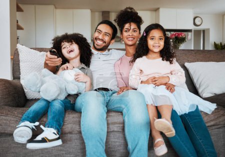 Photo for Mom, dad and children on sofa, watching tv and happy family bonding together in living room. Smile, happiness and parents relax with kids on couch, streaming television show subscription or movies - Royalty Free Image