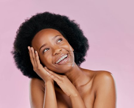 Photo for Thinking, skincare or happy black woman with afro from dermatology, salon cosmetics or wellness. Smile, face or African model with natural beauty or self love isolated on a pink background in studio. - Royalty Free Image