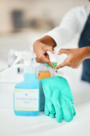 Photo for Heart hands, cleaner and chemical detergent bottle, cleaning kitchen and closeup of supplies for hygiene. Care, support and health with disinfectant spray, housekeeping and person with tools to clean. - Royalty Free Image