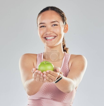 Photo for Portrait, apple and offer of woman isolated on studio, white background for healthy food, healthcare or nutritionist diet. Face of vegan person or model giving green fruit for detox, care and choice. - Royalty Free Image
