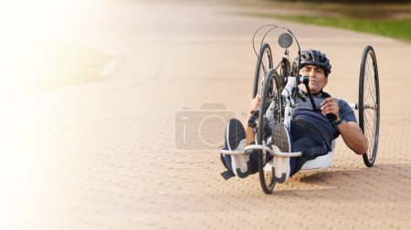 Photo for Man with disability, handbike and outdoor bicycle for sports, race or exercise power with flare of mockup space. Fitness, male athlete with paraplegia and cycling in competition, challenge or contest. - Royalty Free Image