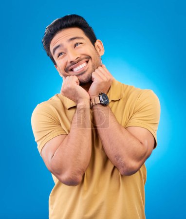 Photo for Happy, smile and man in studio with a dreaming or sweet memory or future facial expression. Happiness, excited and male model from India with positive mindset for planning isolated by blue background. - Royalty Free Image