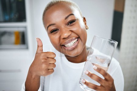 Photo for Thumbs up, yes and portrait of black woman with water for diet success or detox start. Happy, healthy and an African girl with an emoji hand for liquid goal or care with a glass in the morning. - Royalty Free Image