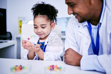 Photo for Science, research and child with her father in the lab working on an experiment or test with sweets. Biology, candy and girl kid student doing project with dad scientist in pharmaceutical laboratory - Royalty Free Image