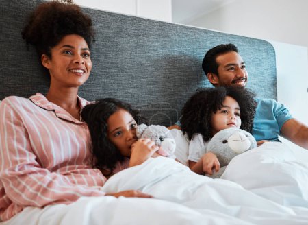 Photo for Bed, home and relax happy family watching tv show, subscription movie or streaming entertainment film. Bonding, morning love or bedroom people watch television, media or cartoon video in apartment. - Royalty Free Image