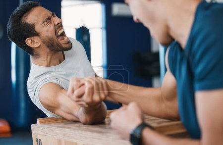 Photo for Strong, loser or men arm wrestling at gym on a table in playful challenge together in fitness training. Game, pain or strong people in muscle power battle for sports, hard competition or tough match. - Royalty Free Image