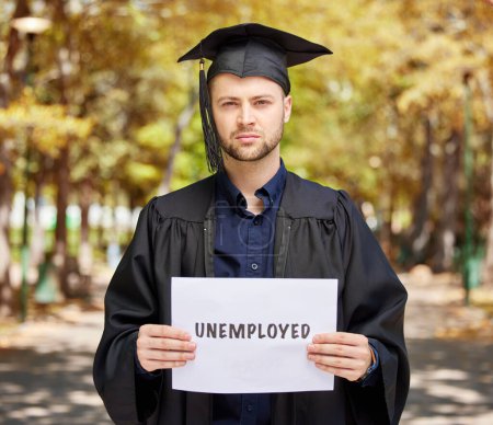 Photo for Portrait, graduation and unemployment with a student man holding a sign outdoor for debt, loans or jobless. Economy, future and depression with an unhappy college pupil during a labor crisis. - Royalty Free Image