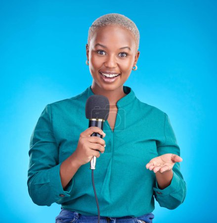 Photo for Woman, microphone and studio portrait for interview, news program or questions for talk show by blue background. Young African reporter, journalist or happy tv host with holding mic, speech and press. - Royalty Free Image