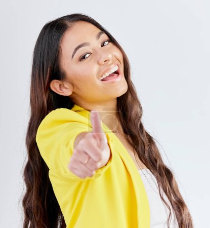 Photo for Portrait, support and woman with thumbs up, achievement and like symbol against a white studio background. Winning, female person or model with hand gesture, sign or positive with review or agreement. - Royalty Free Image