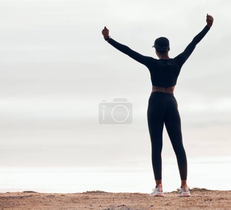Photo for Celebration, fitness and back of woman in nature with achievement, success and workout goals. Sports, mockup space and happy female person with hands in air for exercise, training and running target. - Royalty Free Image