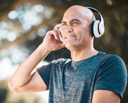 Photo for Happy man, headphones and listening to music in nature for workout, training or exercise outdoors. Male person or mature runner smile with headset for audio streaming or online sound track outside. - Royalty Free Image