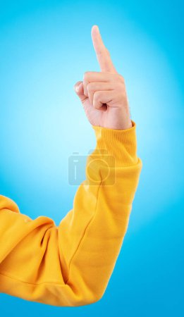 Photo for Man, hands and pointing up finger for idea, solution or remember in memory against a blue studio background. Hand of male person in choice, decision or advertising plan guide, offer or opportunity. - Royalty Free Image