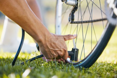 Photo for Air, bicycle and a man fixing wheel outdoor with pump or tools while cycling in nature. Bike, hands and a sports person or athlete with flat tire and maintenance, safety or repair on transportation. - Royalty Free Image