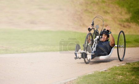Photo for Cycling, nature and speed, man with disability training for competition with motivation and exercise on bike. Motion, workout and person on fast recumbent bicycle for outdoor race, space and mockup - Royalty Free Image