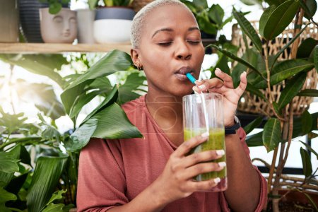 Photo for Nutrition, drinking and black girl with green smoothie for diet with plants for wellness or weightloss. Healthy, woman and enjoy a detox drink with vegetables for vitamins with supplement in home - Royalty Free Image