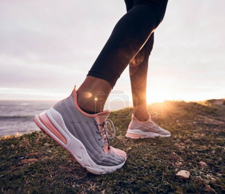Photo for Shoes, closeup and beach ground for fitness, workout and training to start a run. Outdoor, sunset and feet with sports by the sea and ocean for exercise and running in nature with sunshine by sky. - Royalty Free Image