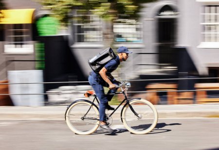 Photo for Delivery man, bicycle and motion blur in city for fast logistics, quick distribution service and order. Courier, guy or travel with speed on bike, cycle and transportation for package in urban street. - Royalty Free Image