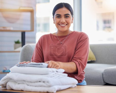 Photo for Cleaning, happy and laundry with portrait of woman in living room for housekeeping service, clothes and fabric. Hospitality, smile and cleaner with person at home for maintenance and washing. - Royalty Free Image