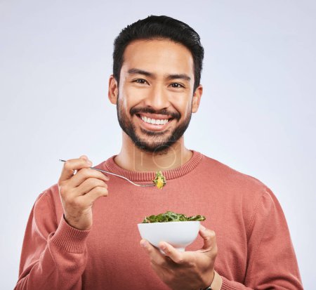 Photo for Fruit, portrait and happy asian man in studio for health, wellness and detox on grey background. Breakfast, salad and face of guy nutritionist smile for healthy, clean or raw diet for vegan lifestyle. - Royalty Free Image