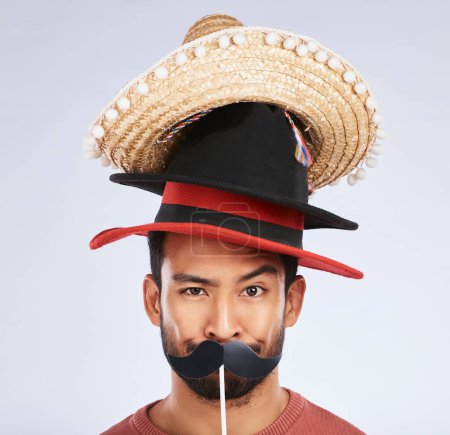 Photo for Photo booth, hat and portrait of man with mustache for comic, humor and funny joke in studio. Happy, Mexican party accessory and silly face of male person on gray background with sombrero for comedy. - Royalty Free Image