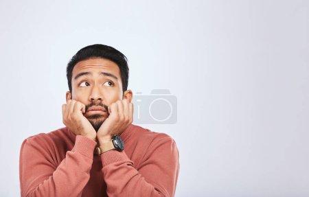 Photo for Depression, thinking and sad asian man in studio for stress or broken heart, lonely or bored on grey background. Doubt, fear and face of male with anxiety, grief or trauma and mental health crisis. - Royalty Free Image
