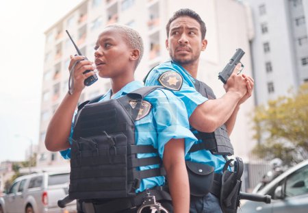 Photo for Team, gun and police in the city for crime, talking into equipment and ready for action. Security, law and a black woman and man speaking into gear while in collaboration for criminal activity. - Royalty Free Image