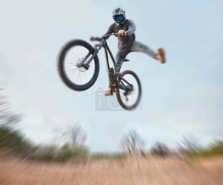Photo for Mountain, bicycle jump and athlete cycling on a bike for extreme sports competition stunt or training in nature. Skill, contest and person workout or action on sky or air trick for fitness with blur. - Royalty Free Image