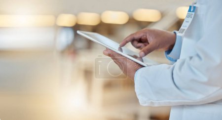 Photo for Digital tablet, closeup and hands of a doctor browsing while doing medical research for a diagnosis. Healthcare, technology and professional male surgeon analyzing medicare data in hospital or clinic. - Royalty Free Image