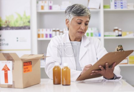 Photo for Woman, doctor and clipboard at pharmacy for inventory inspection, logistics or delivery at drug store. Senior female person, medical or healthcare professional checking pharmaceutical stock or list. - Royalty Free Image
