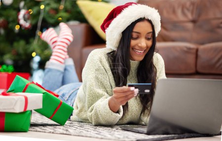Photo for Christmas, online shopping and woman with laptop, credit card for payment for gift with internet banking. Female customer, smile for holiday donation and ecommerce for present, fintech and bank app. - Royalty Free Image