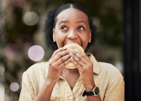 Photo for Thinking, fast food and black woman biting a burger in an outdoor restaurant as a lunch meal craving deal. Breakfast, sandwich and young female person or customer enjoying a tasty unhealthy snack. - Royalty Free Image