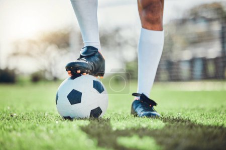 Photo for Legs, sports or man with a soccer ball on a field for exercise, fitness and training for a competition outdoors. Football club, ready or boots of player in a game event or match in stadium on grass. - Royalty Free Image